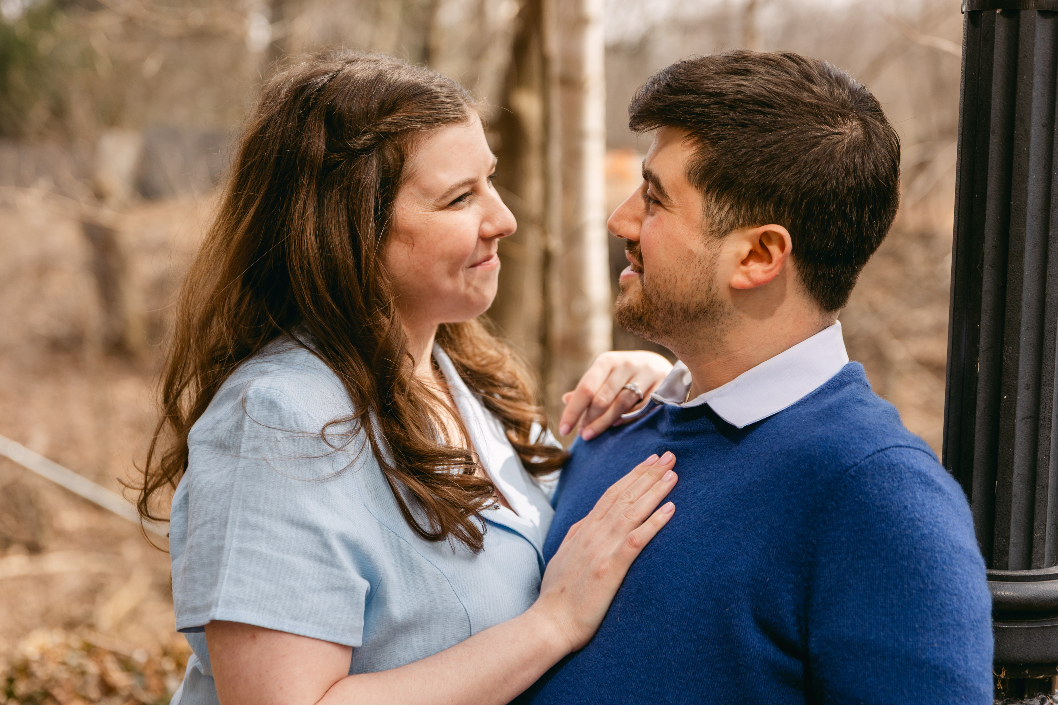 Hailey and Jessie smiling at each other during their engagement photos.