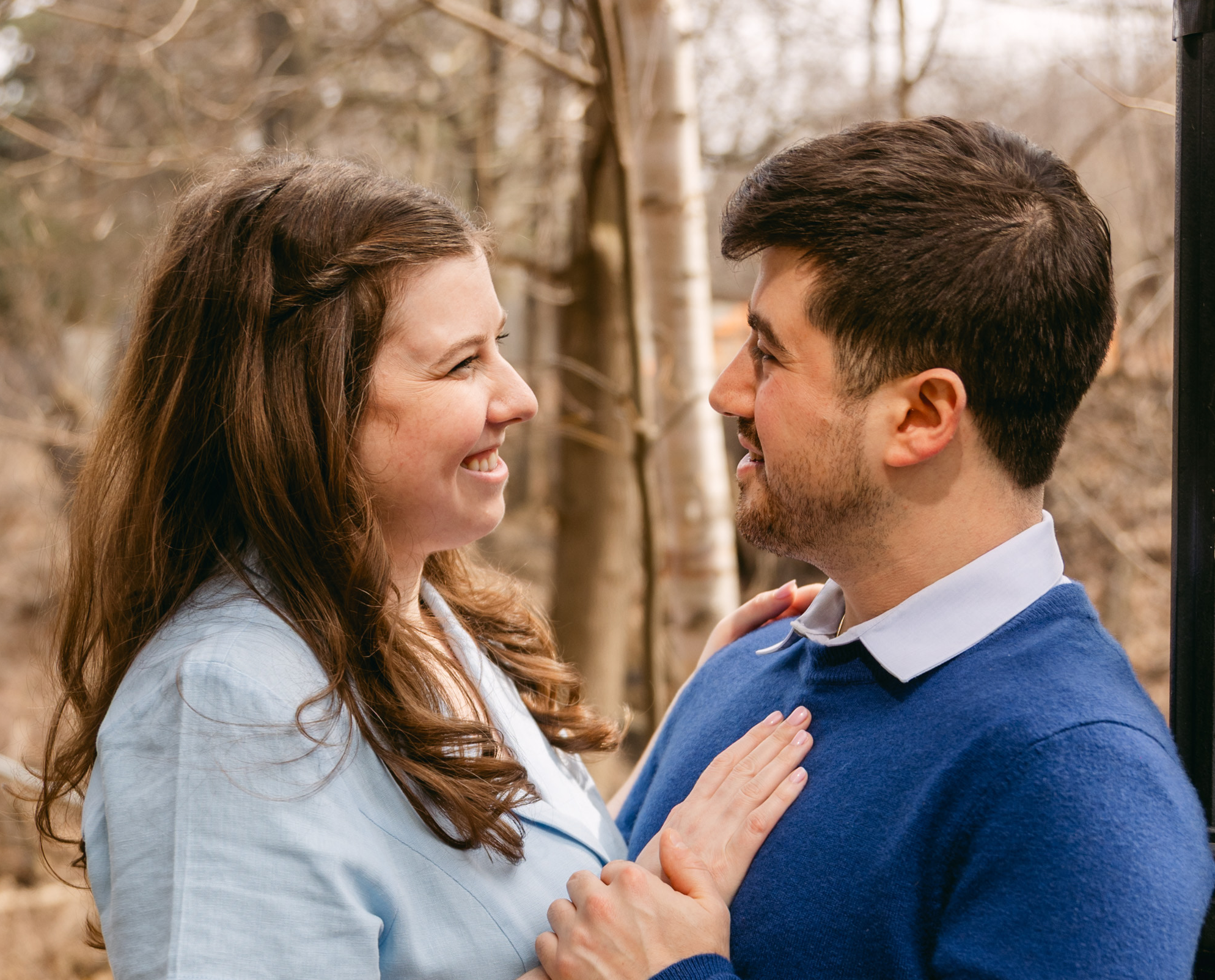 Hailey and Jessie smiling at each other during their engagement photos.
